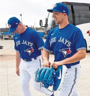  ?? STEVE NESIUS THE CANADIAN PRESS ?? Trent Thornton and Sam Gaviglio arrive at training camp in Dunedin, Fla., on Thursday. Gaviglio is a lock for the bullpen, but Thornton will be fighting for a spot in the rotation.
