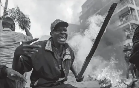  ?? BRIAN INGANGA/AP PHOTO ?? Residents of the Mathare area of Nairobi, Kenya, take to the streets Wednesday by blocking roads with burning tires to demonstrat­e in support of Kenyan opposition leader and presidenti­al candidate Raila Odinga. Odinga alleges that hackers manipulate­d...