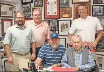  ?? Kevin Myrick ?? Howard “Doc” Ayers (seated, right) was joined by his grandson Tobin, Donnie Jarrell and Olin Gammage and his son Beau gathered to continue a tradition of the Gammage Funeral Home team being the first to sign up to play in the Ayers-Beck Celebrity Golf Tournament.