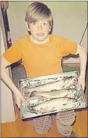  ?? SUBMITTED PHOTO ?? That’s me at about age 9 or 10 with three nice spring mud trout.