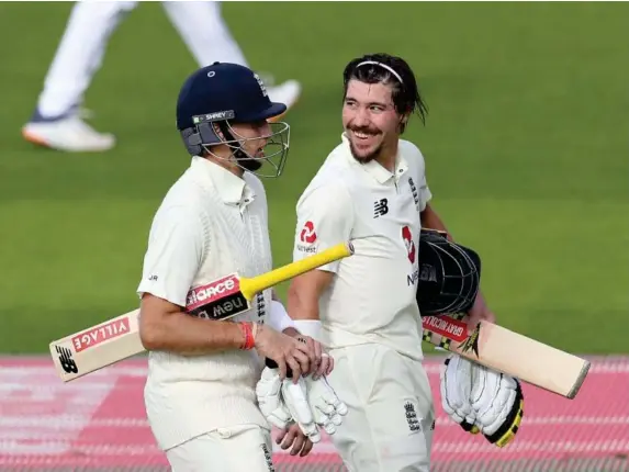  ?? (Reuters) ?? Joe Root and Rory Burns leave the field after declaring on day three