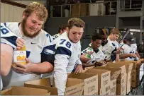  ?? Staff photo by Joshua Boucher ?? ABOVE TOP LEFT: Southweste­rn Oklahoma State football players pack boxes of food for rural communitie­s Friday at Harvest Texarkana. In communitie­s without food shelves or emergency food programs, Harvest Texarkana delivers food.