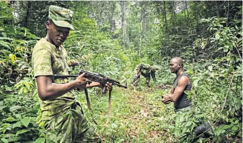  ??  ?? Gabon Park’s rangers are being instructed on how to track elephant poachers by a team of Gurkhas, led by Cpl Gyanendra Rai, inset left