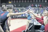  ?? JACOB M. LANGSTON — THE ASSOCIATED PRESS ?? Dayton guard Koby Brea celebrates with fans after their upset win over Kansas on Friday in Lake Buena Vista, Fla.