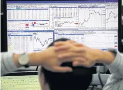  ??  ?? A trader studies market movements on monitors at KEB Hana Bank in Seoul.