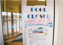  ??  ?? A sign at the Fort Marcy gym entrance tells people the pool is closed and will reopen in March. The women’s locker room is being renovated.