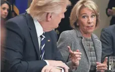  ?? ALEX WONG, GETTY IMAGES ?? President Trump and Education Secretary Betsy DeVos say it’s too difficult to oversee the work of nine student loan vendors.