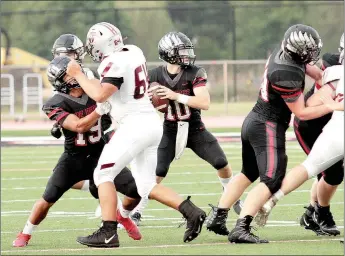  ?? Photograph by Russ Wilson ?? Quarterbac­k junior Logan Stewart (No. 10) is protected by the line as he pulls back to pass Friday night in the contest against the Siloam Springs Panthers in Blackhawk Stadium. Stewart led the offense with 20 rushing yards and 187 yards through the air in 12 of 24 passing.