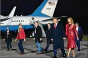  ?? DOUG MILLS / THE NEWYORK TIMES ?? President Donald Trump and first lady Melania Trump arrive for an event forGeorgia’s Republican senators, Kelly Loeffler (left) and David Perdue (second fromleft), at an airport in Valdosta.