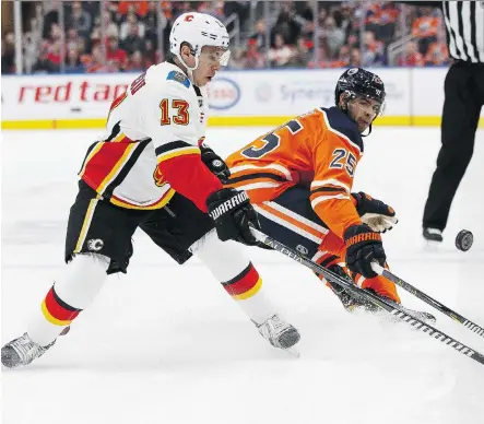  ?? IAN KUCERAK ?? Edmonton’s Darnell Nurse battles Calgary’s Johnny Gaudreau during the Battle of Alberta Thursday night at Rogers Place in Edmonton, where the provincial rivals went to a shootout before the hometown Oilers emerged with a 4-3 victory on Connor McDavid’s...