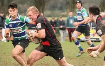  ??  ?? Stephen Horan of Gorey tries to make life difficult for Arklow’s John Furlong.