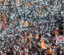  ?? — AFP ?? (Left) People hold Catalan pro-independen­ce flags during a demonstrat­ion in Barcelona on Saturday. Spanish Prime Minister Mariano Rajoy (centre) upon his arrival in Barcelona on Sunday.