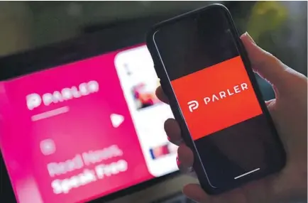  ?? Olivier Douliery AFP via Getty Images ?? of Parler’s features remain clunky, though functions largely resemble Twitter’s. The color scheme: MAGA red.