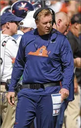  ?? ANDREW SHURTLEFF/THE DAILY PROGRESS VIA AP ?? Head coach Bronco Mendenhall and his Virginia team beat Illinois, a Power Five foe, 42-14.