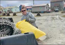  ?? Photo by Robin Johnson ?? AFTER THE STORM— Katie O’Connor drops of trash bags at Old St. Joe’s Community Hall during the City wide clean up on Saturday, September 24.