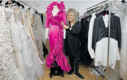  ?? Photo / AP ?? Elizabeth Emanuel stands beside a replica of an evening gown she designed for Diana.