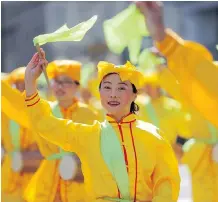  ??  ?? Members of Falun Dafa participat­e in the parade.