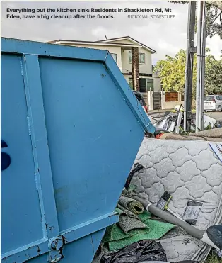  ?? RICKY WILSON/STUFF ?? Everything but the kitchen sink: Residents in Shackleton Rd, Mt Eden, have a big cleanup after the floods.