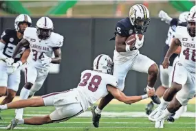  ?? ANDREW NELLES/THE TENNESSEAN ?? Vanderbilt wide receiver Jayden McGowan tries to evade Alabama A&M place kicker Luke Moffett during on Sept. 2.