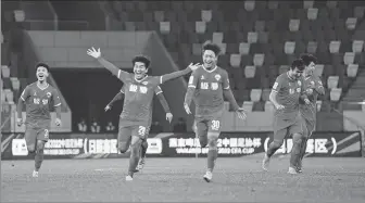  ?? ?? Jingchuan Wenhui players can’t contain their joy after reaching the third round of the CFA Cup on Thursday in Rizhao, Shandong province, thanks to a shock victory over Chinese Super League side Beijing Guo’an (right).