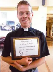  ?? St. Thomas The Apostle Episcopal Church and School ?? Father Mike Stone of St. Thomas the Apostle Episcopal Church and School accepts the Ecumenical Partner of the Year for 2015 award from Interfaith Caring Ministries of League City.