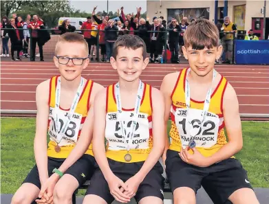  ?? ?? Three cheers
U13s Cameron Chambers, Luke Evans, Jack Duffin with Law supporters in suuporting in the background