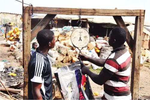  ?? Photos
Ikechukwu Ibe ?? Some scavengers weigh scrap on a scale