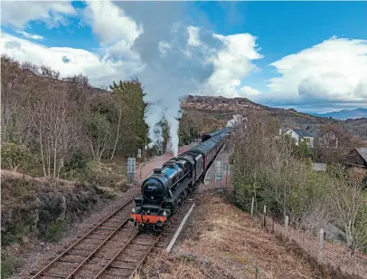  ??  ?? ‘Black Five' No. 45407 sets off from Arisaig with the afternoon ‘Jacobite' for Mallaig on April 27, while K1 No. 62005 departs in the other direction with the morning train, returning to Fort William. DAVE COLLIER