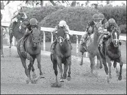  ?? Arkansas Democrat-Gazette/MITCHELL PE MASILUN ?? Classic Empire, ridden by Julien Leparoux (center), passes the field down the stretch to win the Arkansas Derby at Oaklawn Park in Hot Springs on Saturday.