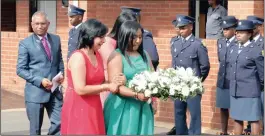  ??  ?? Lee Ann Naidoo (wearing greeen) and her mother, Charmaine, laid a wreath at the wall. Lee Ann’s dad, Captain Basil Naidoo, was shot dead by a robber in March.