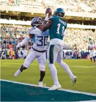  ?? ?? Eagles wide receiver A.J. Brown catches the ball for a touchdown after it skimmed cornerback Tre Avery’s facemask.