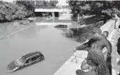  ?? CRAIG RUTTLE/AP ?? High water swamps cars and trucks on an expressway Thursday in the Bronx borough of New York City.