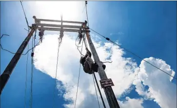  ?? Vivek Singh For The Times ?? A TECHNICIAN works in Barnali. The government hired 400 rural engineers for its electrific­ation plan.