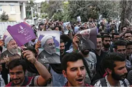  ?? Behrouz Mehri / AFP / Getty Images ?? Supporters of newly re-elected Iranian President Hassan Rouhani take to the streets to celebrate his victory Saturday in downtown Tehran. Iran’s president oversees a vast state bureaucrac­y employing more than 2 million people.