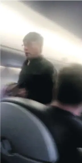  ??  ?? This image was from a video provided by Audra D. Bridges showing a passenger being removed from a United Airlines flight in Chicago. Video of airport police dragging the passenger from the flight sparked an uproar Monday on social media, and a...