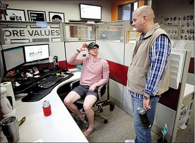  ?? NWA Democrat-Gazette/DAVID GOTTSCHALK ?? David Temple visits Tuesday with employee Roman Johnson at the company’s booking office in Fayettevil­le.