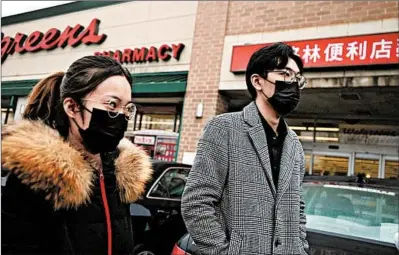  ?? ANTONIO PEREZ/CHICAGO TRIBUNE ?? Hai Xia, right, leaves the Walgreens in Chinatown empty-handed Friday after hoping to buy a specific brand of surgical face masks.