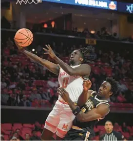  ?? KENNETH. K. LAM/STAFF ?? Maryland’s Jahnathan Lamothe, going in for a layup against UMBC’s Alpha Chibambe, had 10 points and three rebounds in the Terps’ 105-65 win over Alcorn State on Tuesday.