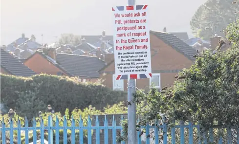  ?? AFP ?? Posters appear in unionist areas of West Belfast, calling off planned protests in Belfast, Northern Ireland on Saturday following Prince Philip’s death.