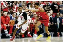  ??  ?? Ohio State’s Luther Muhammad (left) brings the ball upcourt past Maryland’s Aaron Wiggins in a Big Ten battle Sunday in Columbus. OSU shot 40% from 3-point range, and Muhammad hit four.