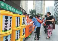  ?? WANG ZHUANGFEI / CHINA DAILY ?? Beijing residents learn about waste sorting in the Yilianxuan residentia­l community.