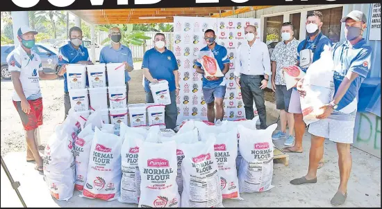  ?? Picture: REINAL CHAND ?? Fiji Football Associatio­n president Rajesh Patel (4th from left) hands over food rations to Lautoka Football Associatio­n players at the Design Engineerin­g Ltd yard in Navutu, Lautoka.