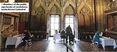  ?? ?? > Members of the public sign books of condolence inside Bristol Cathedral