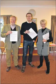  ??  ?? Arran Community Trust chairman Barry Mochan is flanked by Arran Economic Group developmen­t director Sheena Borthwick-Toomey and Arran Economic Group chairman Tom Tracey with the membership forms. 01_B50ADT01