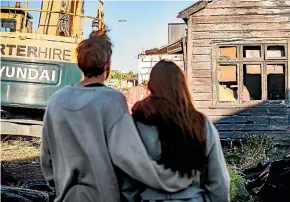  ?? ?? D’ath and girlfriend Leticia Nixon, who was also in the building at the time of the fire, look on as the place they had called home is demolished.