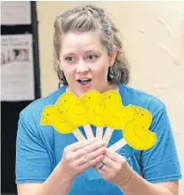  ??  ?? Shelby Farnsworth leads a “Rhythm & Rhyme” session for children and parents at the Yukon Community Center.