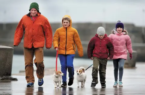 ?? Photo: Steve Humphreys ?? WINTER WALK: Out for a stroll along the East Pier at Dun Laoghaire yesterday was Niall Gibney from Blackrock, Co Dublin, with children Sasha (11), Rudy (8) and Pia (10) and dogs Rex and Millie.