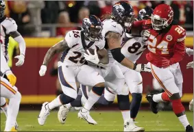  ?? CHARLIE RIEDEL — THE ASSOCIATED PRESS ?? Broncos running back Mike Boone (26) runs with the ball as Chiefs linebacker Melvin Ingram III (24) defends during the first half of an NFL football game, Dec. 5, in Kansas City, Mo.