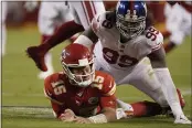  ?? CHARLIE RIEDEL — THE ASSOCIATED PRESS ?? Kansas City Chiefs quarterbac­k Patrick Mahomes (15) is slow to get up after throwing under pressure from New York Giants defensive end Leonard Williams (99) during the first half Monday in Kansas City, Mo.