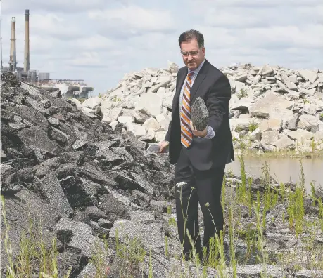  ?? DAN JANISSE ?? MP Brian Masse checks out debris on a property along the Detroit River next to the Ojibway Shores property on Wednesday. He is concerned about the potential sale of the land, and the impact on the environmen­tally significan­t area that could result if it's used for heavy industry.